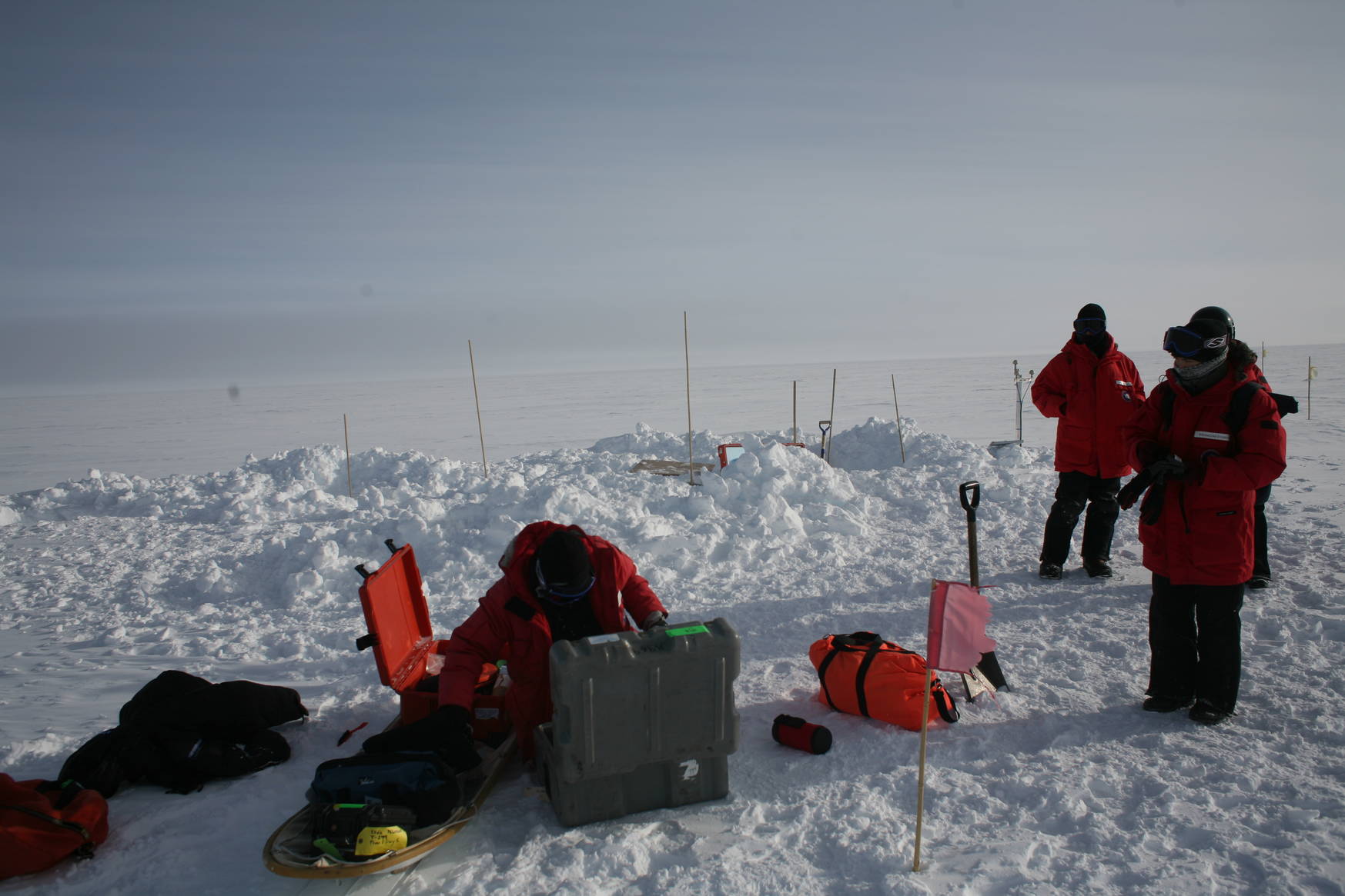 Working on the seismological detectors requires digging out holes with a shovel.