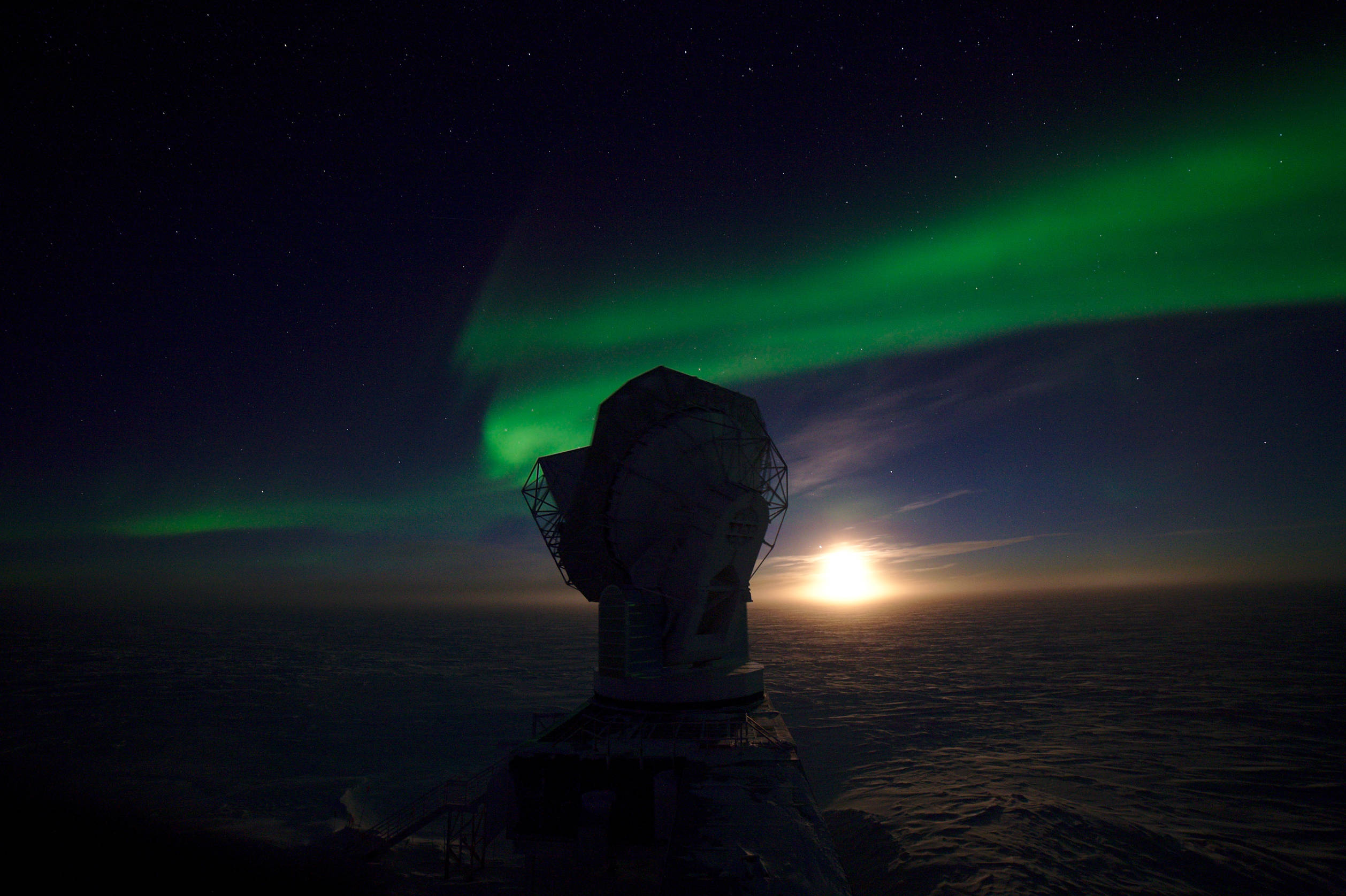 Early May, the moon behind the South Pole Telescope. The auroras were so strong that night that they were visible despite the glaring moon light.